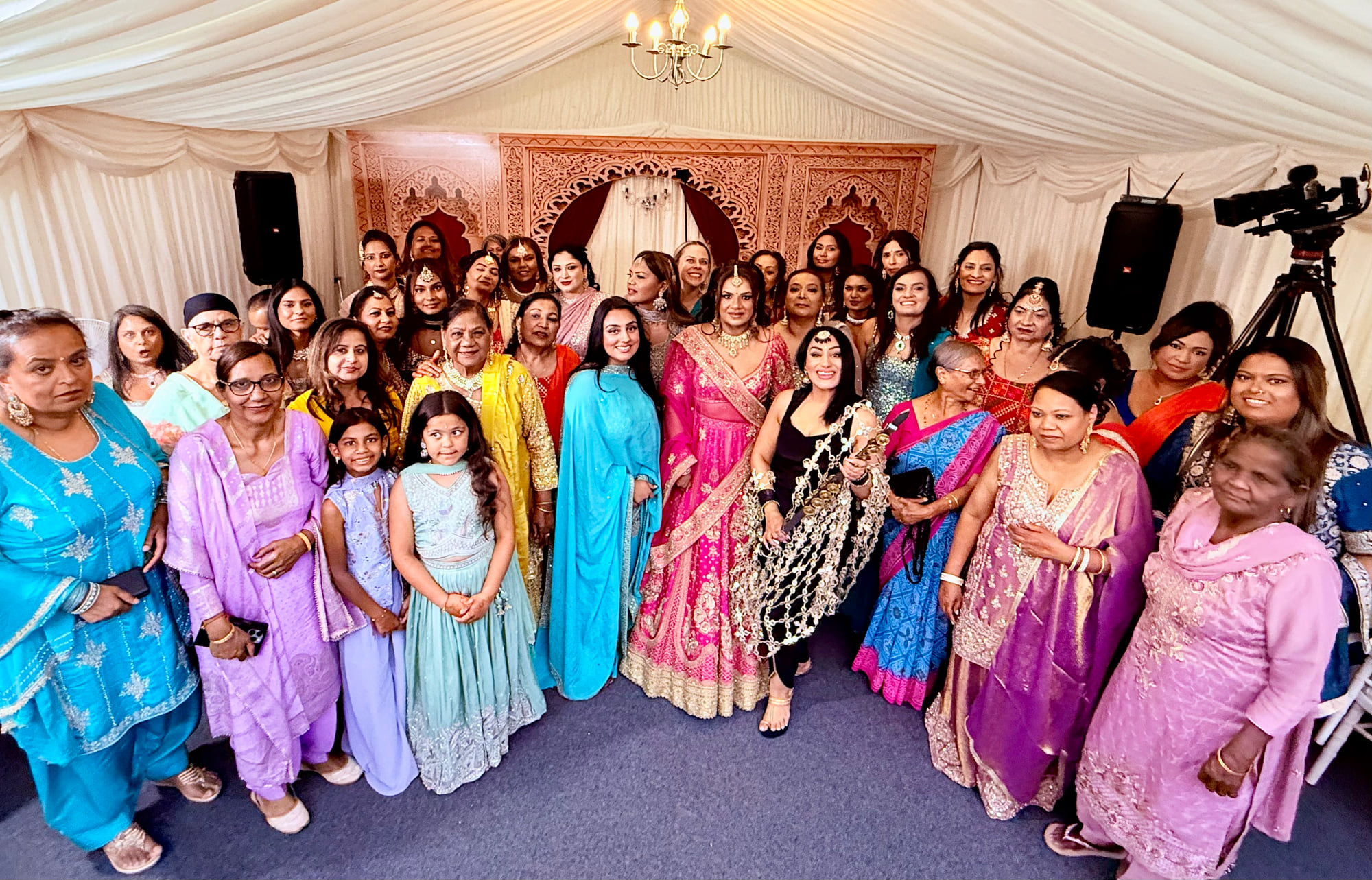 Reena Kaur with the bride and ladies sangeet guests in a decorated marquee