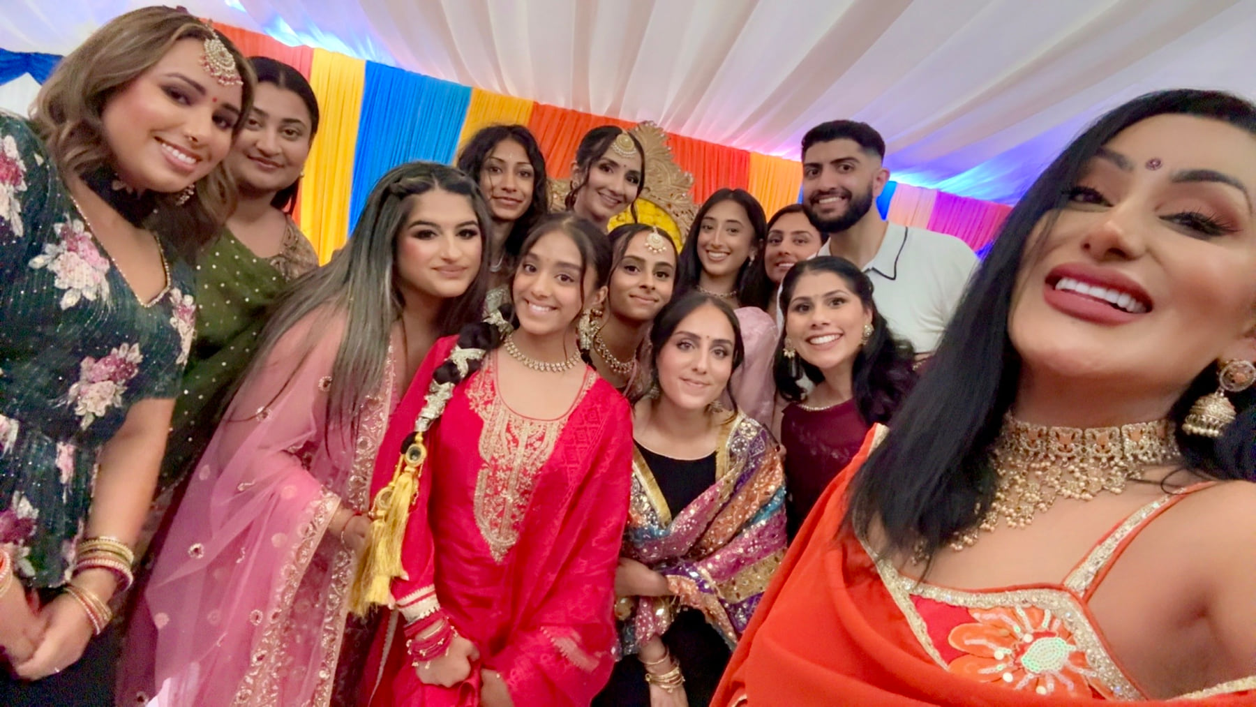 Reena Kaur taking a selfie with smiling guests at a Sangeet